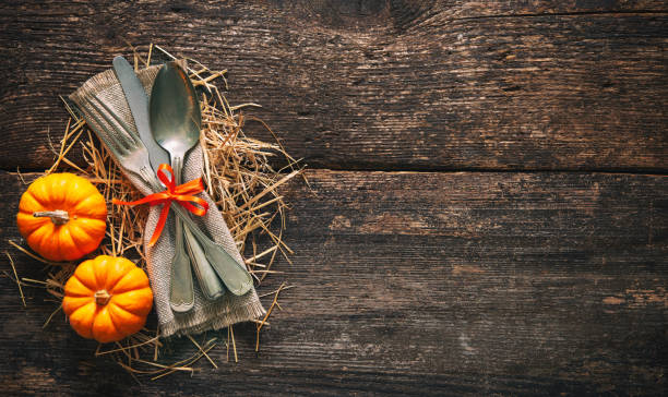 istock Autumn background with vintage place setting on old wooden table 1057528880