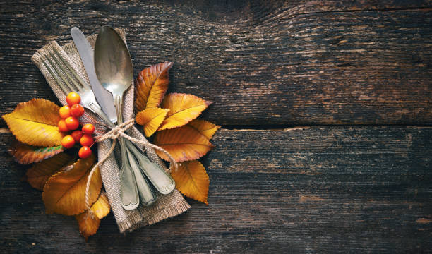 istock Autumn background with vintage place setting on old wooden table 1057528882