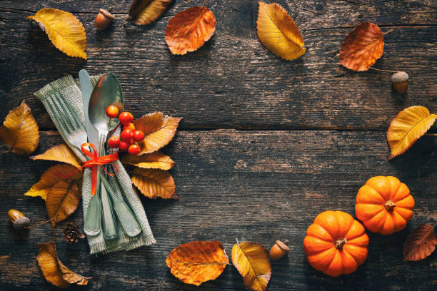 istock Autumn background with vintage place setting on old wooden table 1057528884
