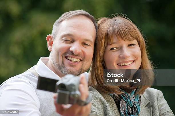 Man And Woman With Video Camera Stock Photo - Download Image Now - Adult, Camera - Photographic Equipment, Cheerful