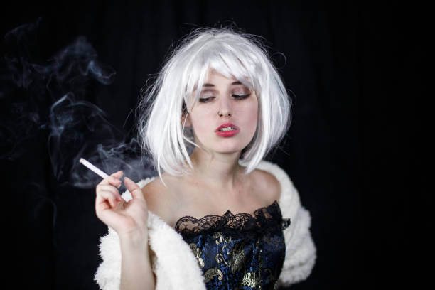 istock Elegant woman smoking cigar 1057532680