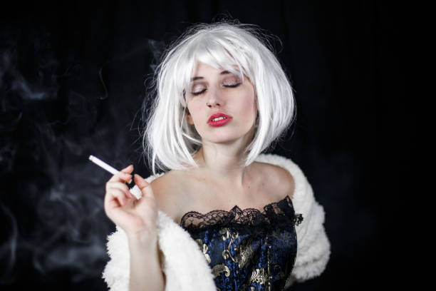 istock Elegant woman smoking cigar 1057532718