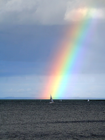 Sailboats and beautiful rainbow over the Irish Sea