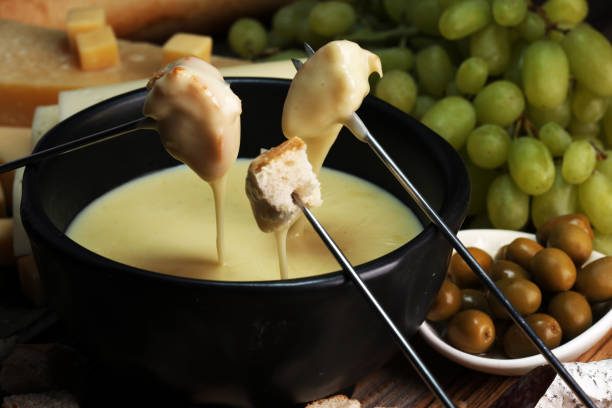 istock Gourmet Swiss fondue dinner on a winter evening with assorted cheese 1057538798