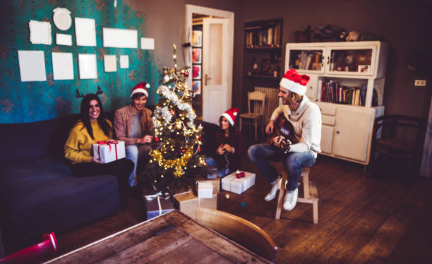 istock happiness man playing the guitar for christmas at home 1057547064