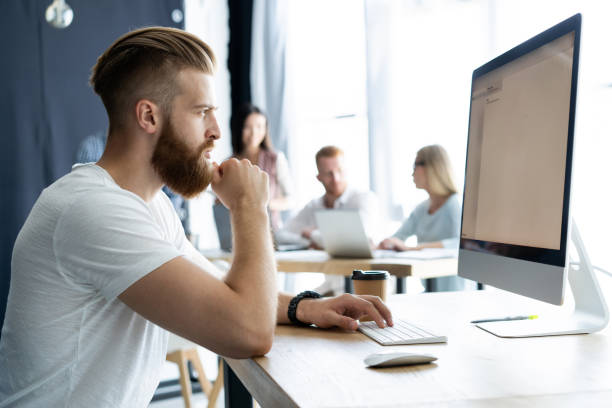 istock Creative office. Young modern colleagues in smart casual wear working while spending time in the office. 1057551596