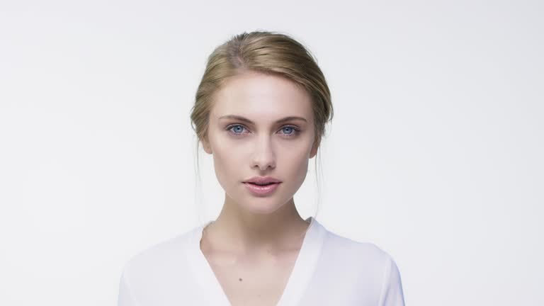 Portrait of young woman against white background