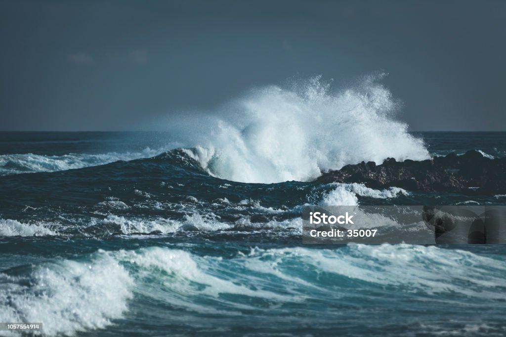 waves splashing indian ocean storm waves splashing at coastal rocks at la reunion island, mascarene islands, french overseas territory. Sea Stock Photo