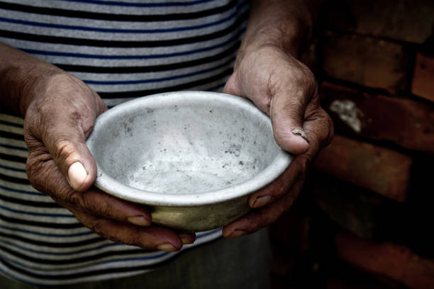 istock The poor old man's hands hold an empty bowl. The concept of hunger or poverty. Selective focus. Poverty in retirement. Homeless. Alms 1057556012