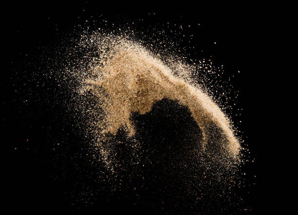 Sand flying explosion isolated on black background ,throwing freeze stop motion object design