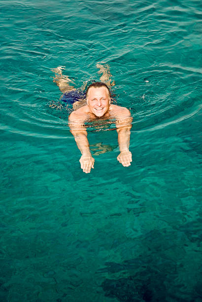 istock happy smiling man swimming 105755825