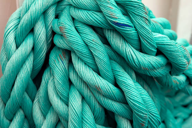 istock Nautical background. Old blue frayed ship rope closeup. 1057559262
