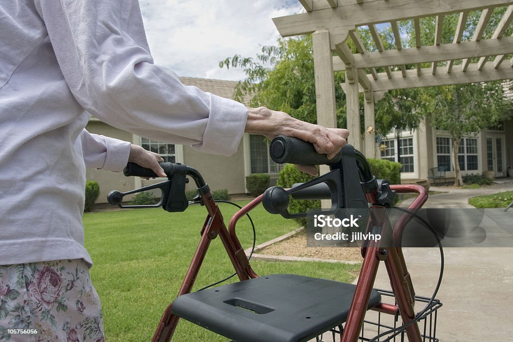 Elderly woman using a walker outdoors  Independence - Concept Stock Photo