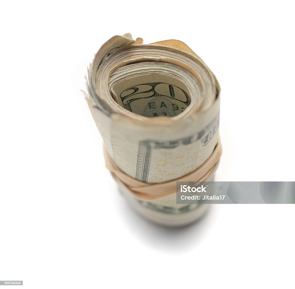 Rotolo di soldi con fasce in gomma su sfondo bianco - Foto stock royalty-free di Ambientazione interna