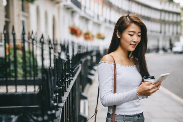 istock Young woman checking her phone 1057562894