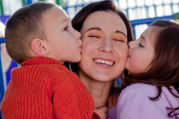 istock Two Children Kissing Mom 105756549