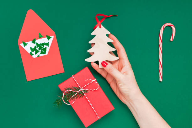 istock Christmas greeting card with woman hand 1057569850