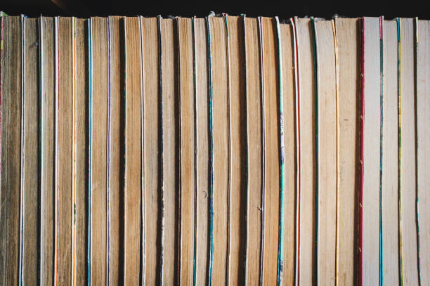 istock Rows of old pocketbooks on the book shelf in library. 1057571370