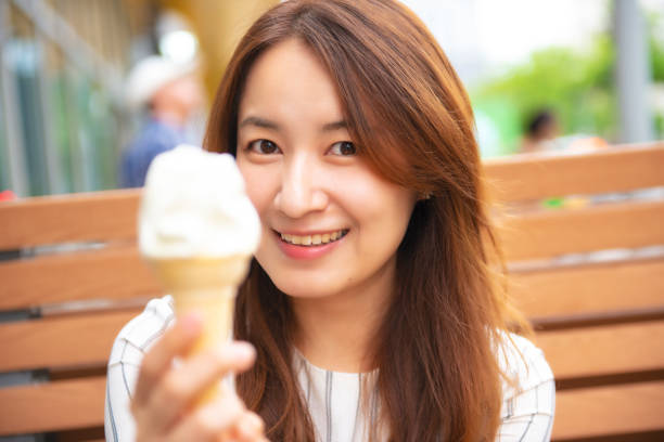 istock Pretty asian woman eating ice cream 1057572482