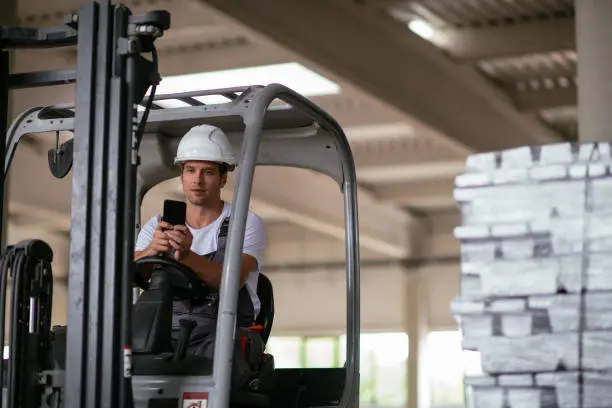 Photo of Factory worker driving the forklift