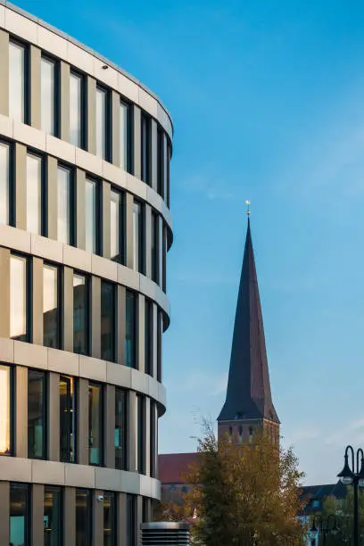 Modern building and church in the city Rostock, Germany.