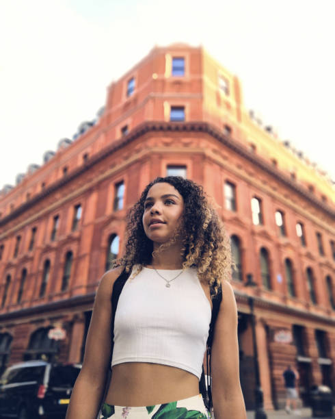 istock Woman Standing Against Building In City 1057574992