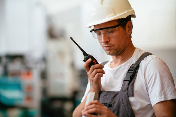 istock Handsome factory worker with walkie-talkie 1057576086