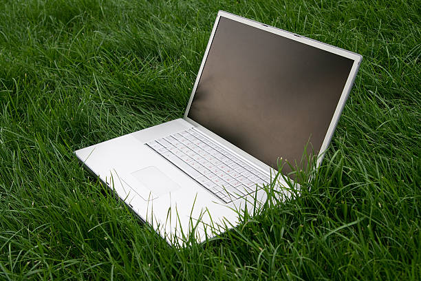 Laptop on a grass stock photo