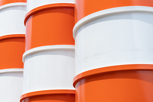 orange and white steel silo. metal tank background and texture.