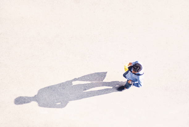 istock Directly Above Shot Of Man Walking On Road 1057583116