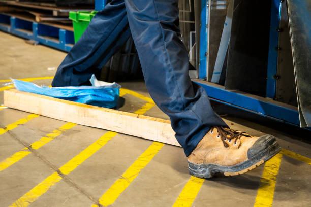 istock An industrial safety topic.  A worker tripping over a trash on a factory floor 1057590302