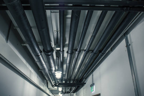 istock Industrial heating pipes under celling or another household communications pipelines in modern building 1057590492