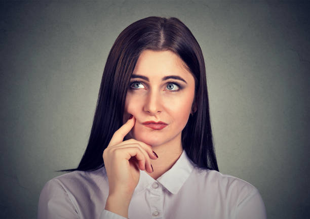 istock Pensive young woman in doubts 1057593434