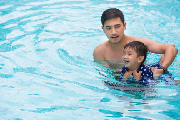 istock Father And Son In Swimming Pool 1057593984