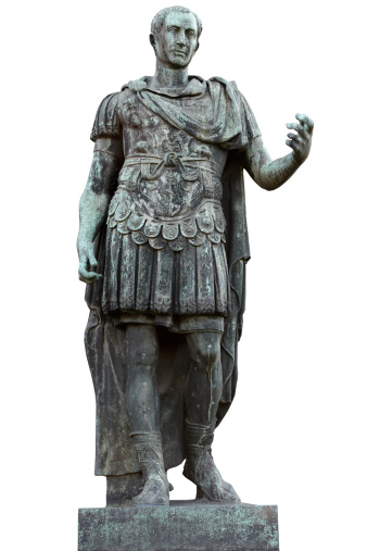 A detailed view of the bronze statue of the Emperor Gaius Iulius Caesar Augustus, also know as Octavian or Augustus, along the Viale dei Fori Imperiali (Avenue of the Imperial Forums), in the ancient heart of Rome. This bronze statue, placed in front of the Forum of Augustus, is a copy of the marble original currently preserved in the Vatican Museums. Caesar Augustus was the first Roman emperor, revered as father of the homeland (Patri Patriae) and artecife of a long period of domination, prosperity and peace throughout the empire, known as Pax Romana or Pax Augustea. The Roman Forum, one of the largest archaeological areas in the world, represented the political, legal, religious and economic center of the city of Rome, as well as the nerve center of the entire Roman civilization. In 1980 the historic center of Rome was declared a World Heritage Site by Unesco. Image in original 4:3 ratio and high definition quality.