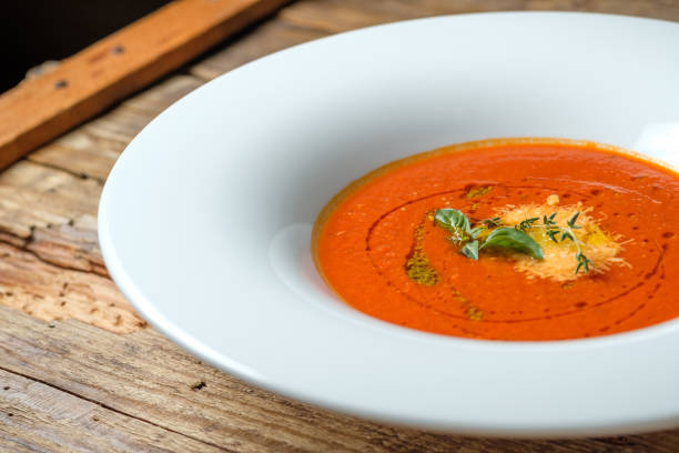 istock Vegetable tomato soup with cheese and green herbs 1057597166
