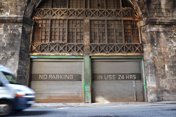 istock No parking place, in use 24 hours notice on old rusty vintage paint corrugated iron garage, Edinburgh, Scotland, United Kingdom 1057597800