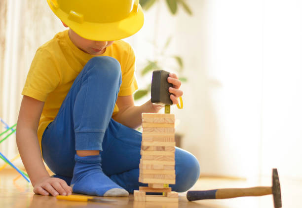 istock Beautiful little handyman is playing with hand tools 1057599718