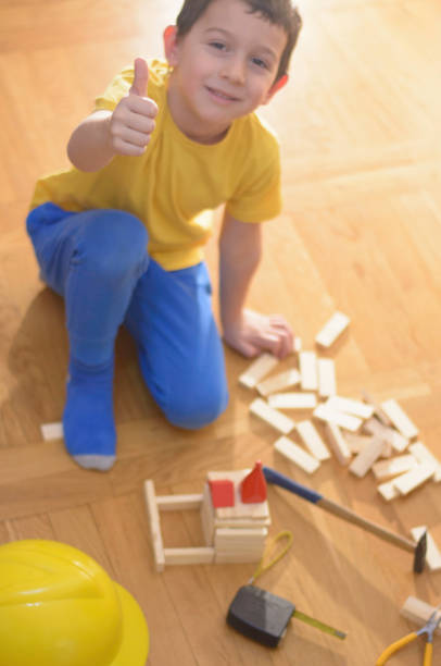 istock Beautiful little handyman is playing with hand tools 1057599826