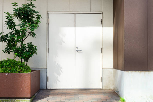 istock sidewalk by street wall & door 1057603142