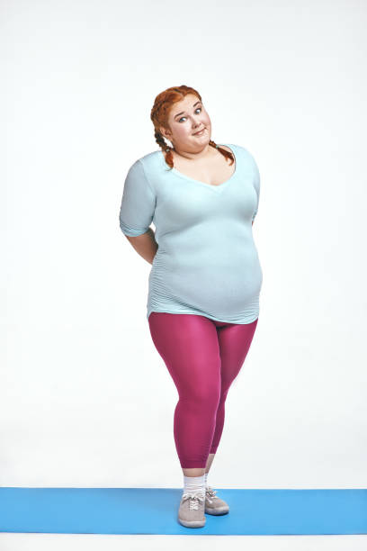 istock Funny, amusing, red haired, chubby woman is shy 1057605040