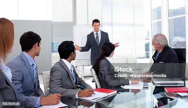 Confident Businessman Giving A Presentation To His Team Stock Photo - Download Image Now