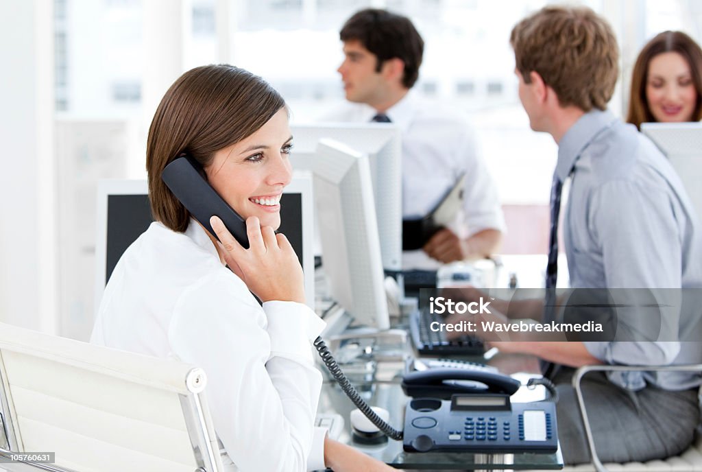 Enthusiastic businesswoman talking to the phone Enthusiastic businesswoman talking to the phone in the open-space Adult Stock Photo