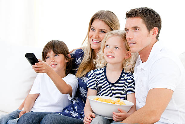 istock Smiling family watching TV 105760688