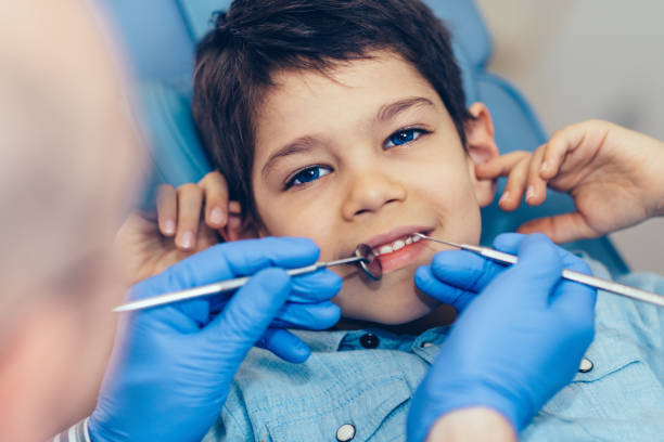 istock Cropped Image Of Dentist Examining Boy At Clinic 1057607470