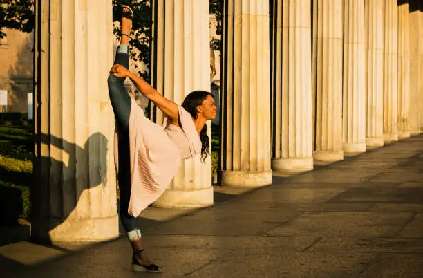 Photo of The young black beautiful woman with afro curly hair dancing