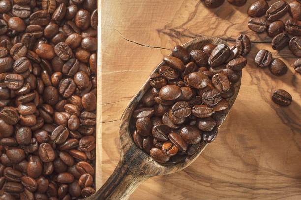 istock Coffee beans and shovel on wooden ground 1057610250
