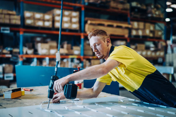 istock Ginger Australian guy working with drill in factory 1057613378