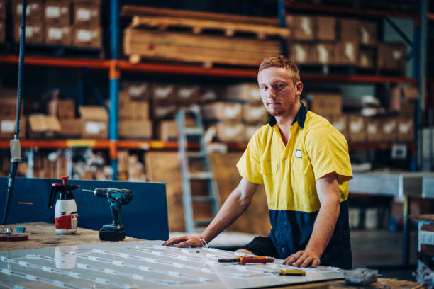 istock Ginger Australian guy working with drill in factory 1057613426