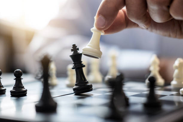 istock Hands of confident businessman colleagues playing chess game to development analysis new strategy plan, leader and teamwork concept for win and success 1057613480